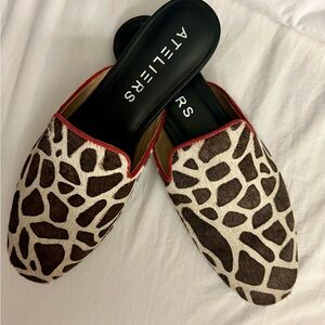 Ateliers slip on giraffe print mule.